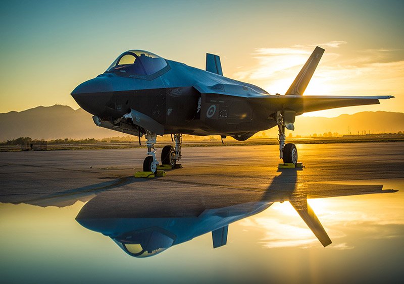 The sun sets behind an Australian F-35A Lighting II aircraft at Luke Air Force Base, Ariz., June 27, 2018. The first Australian F-35 arrived at Luke in December, 2014. Currently six Australian F-35's are assigned to the 61st Fighter Squadron where their pilots train alongside U.S. Air Force pilots. (U.S. Air Force photo by Staff Sgt. Jensen Stidham) Note: This image was created by placing a reflective surface in front of the the camera lens.-Sky Sovereignty: The 5 Most Lethal Fighter Jets Dominating the Clouds in 2026
